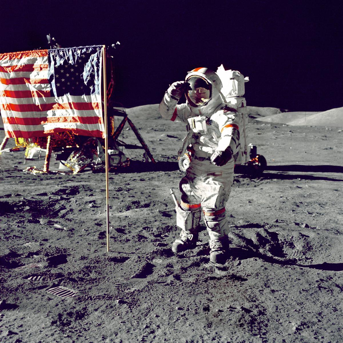 Astronaut standing on the moon's surface with the lunar module in the background