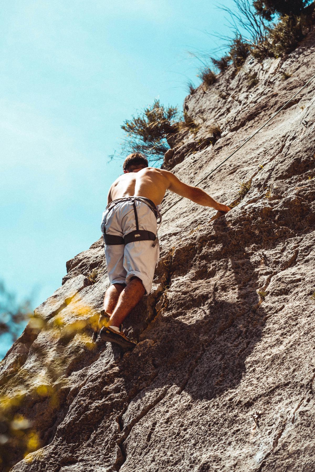 An individual climbing a mountain symbolizing personal growth