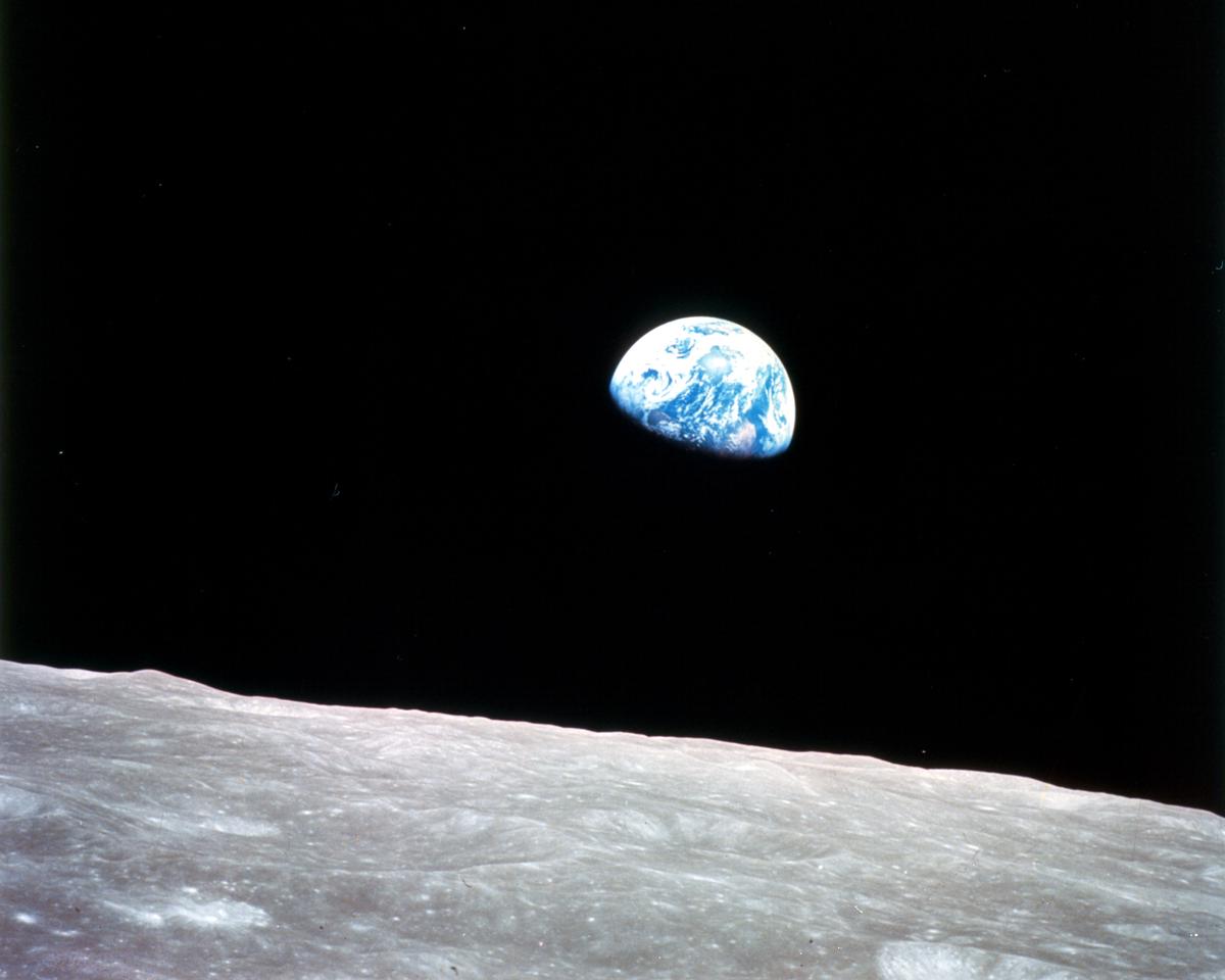 Earth as seen from the lunar surface, a large colorful orb against the black sky