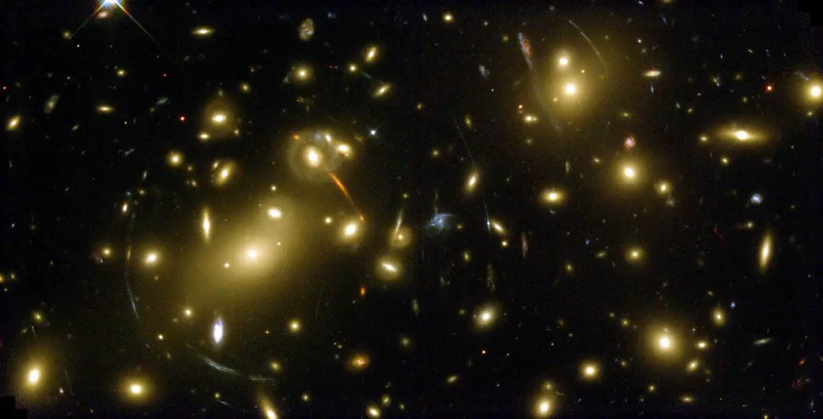 Gravitational lensing effect showing distorted images of distant galaxies around a massive galaxy cluster