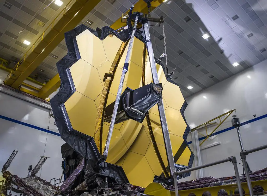 A sequence showing the James Webb Space Telescope's launch on an Ariane 5 rocket and its subsequent deployment phases in space