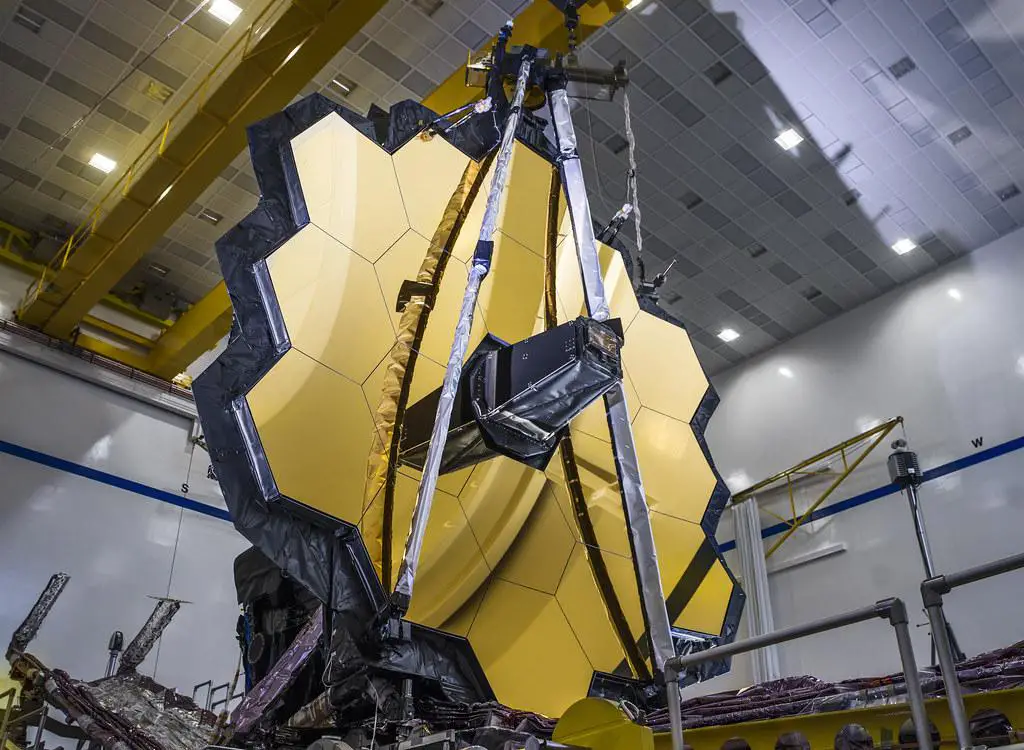 An image of the James Webb Space Telescope's primary mirror, fully aligned and ready to capture the wonders of the universe, with its 18 hexagonal gold-coated beryllium mirror segments forming a single, smooth surface.