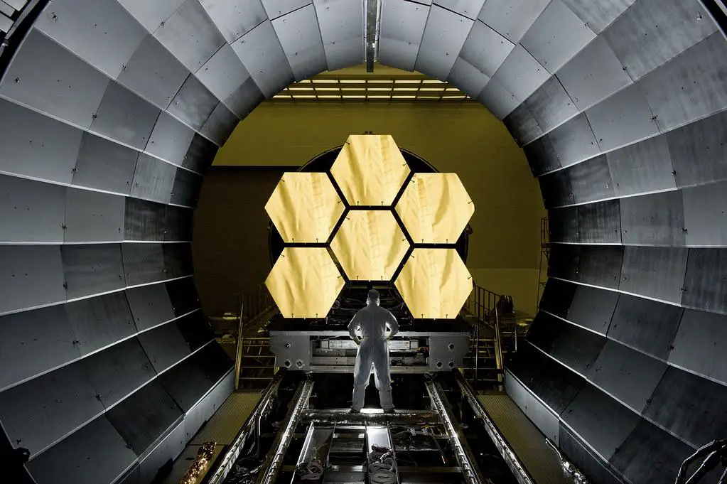 Composite image showcasing the innovative features of the James Webb Space Telescope's primary mirror, including its beryllium structure, gold coating, and actuator system