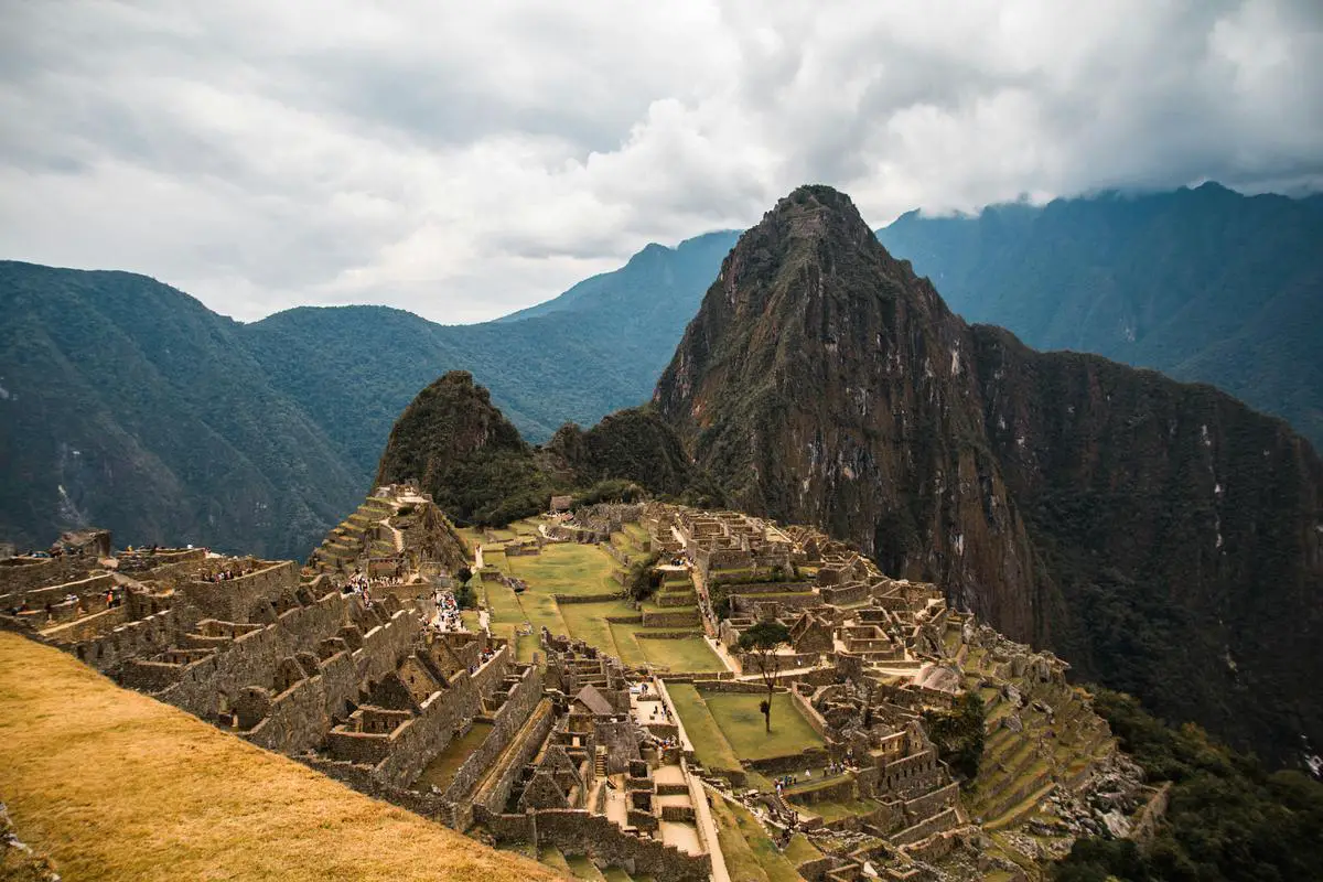 The ancient Inca citadel of Machu Picchu, perched high in the Andes Mountains of Peru, showcasing the remarkable terraced fields, sophisticated stonework, and intertwined ruins.