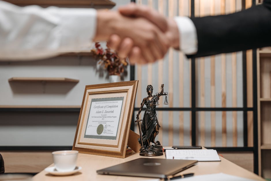 A person shaking hands in a business setting with scales of justice in the background