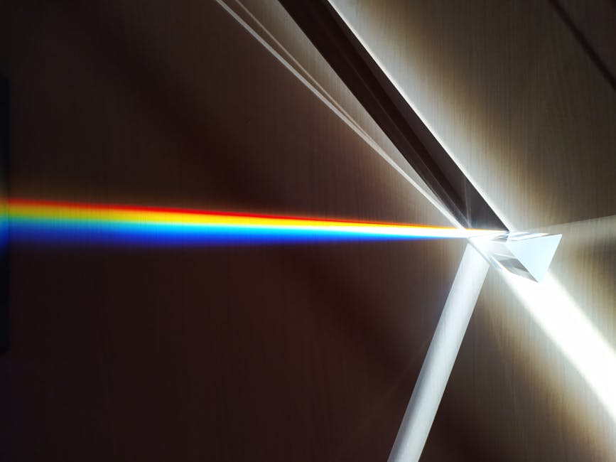 A beam of white sunlight passing through a prism, dispersing into a vibrant rainbow spectrum