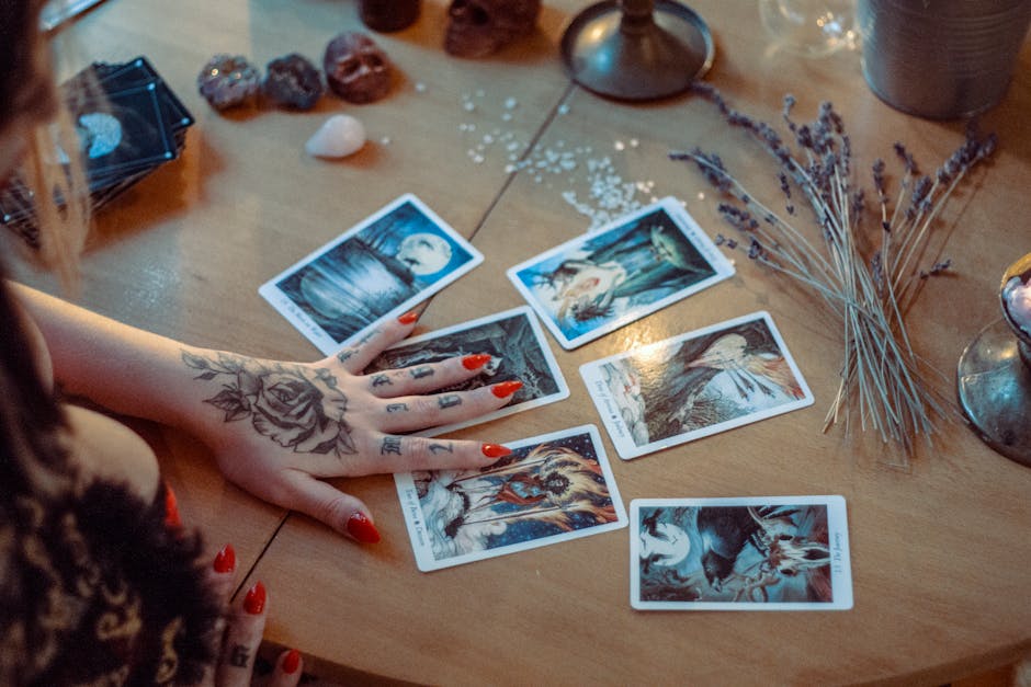 A person performing a tarot spread focused on relationships, with cards arranged in a specific pattern