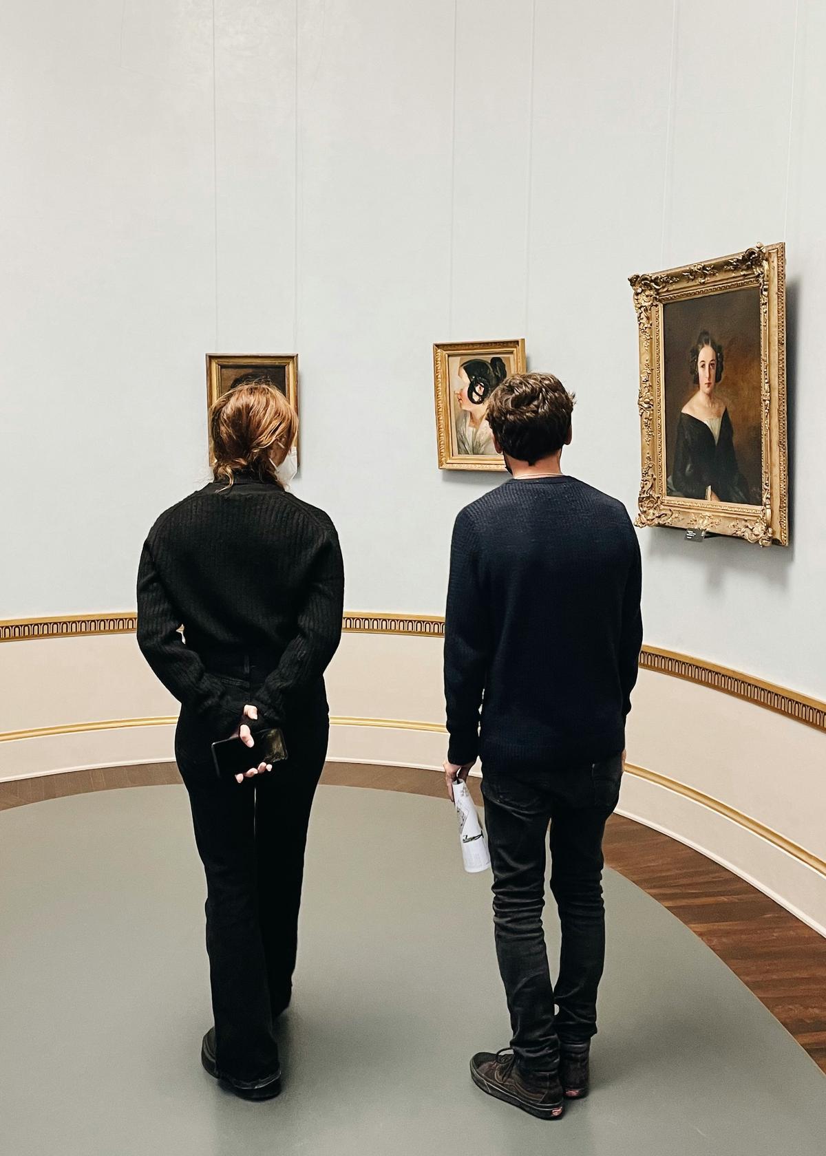 A couple examining an interesting exhibit in a museum